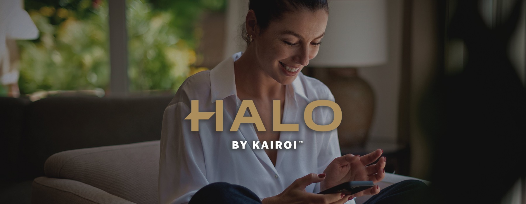 a woman smiling and interacting with her device